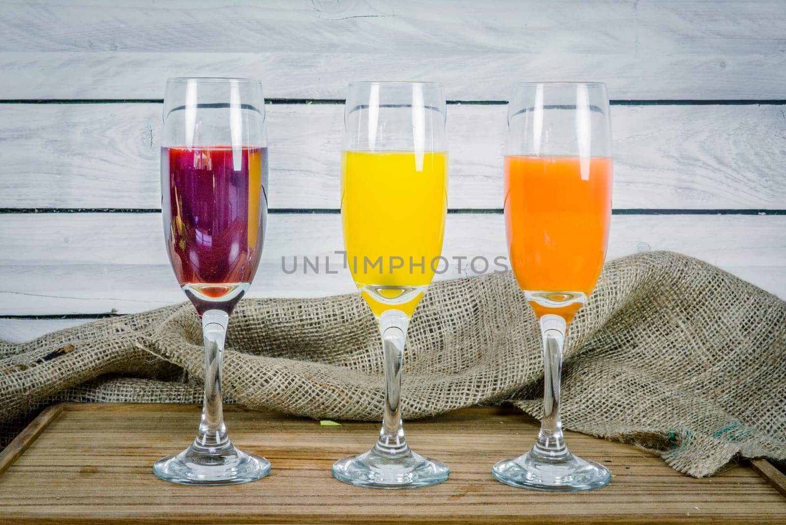 Colorful juice variations on a wooden table