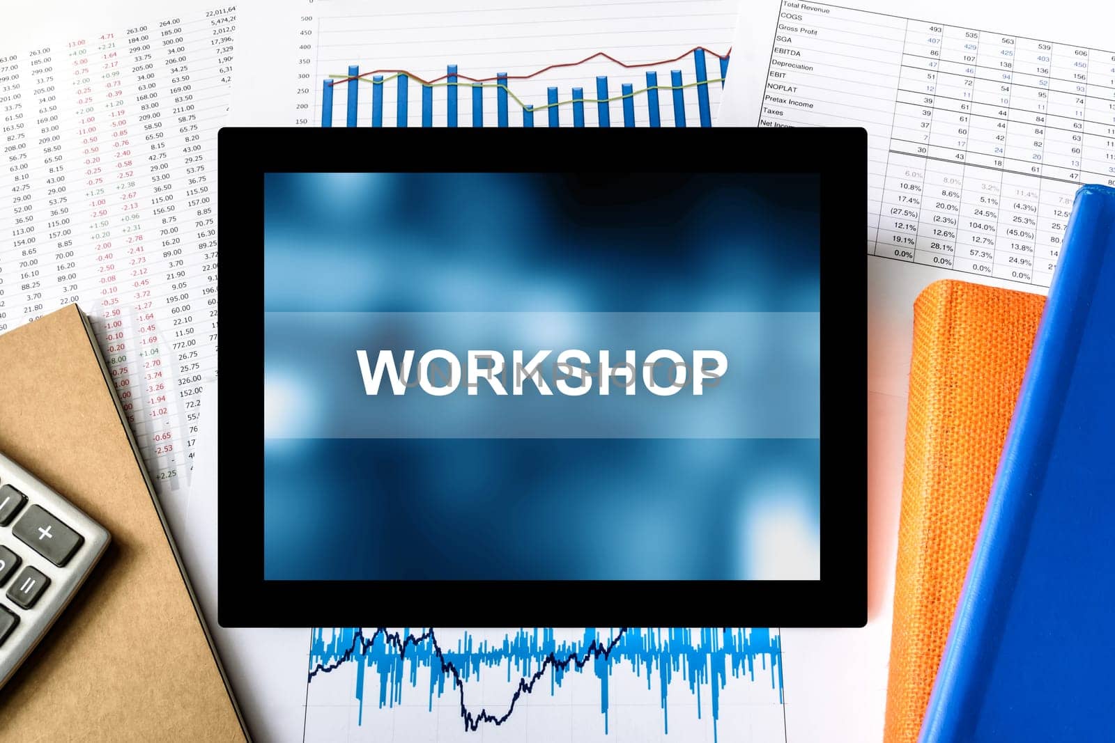 workshop word on tablet with financial graph background