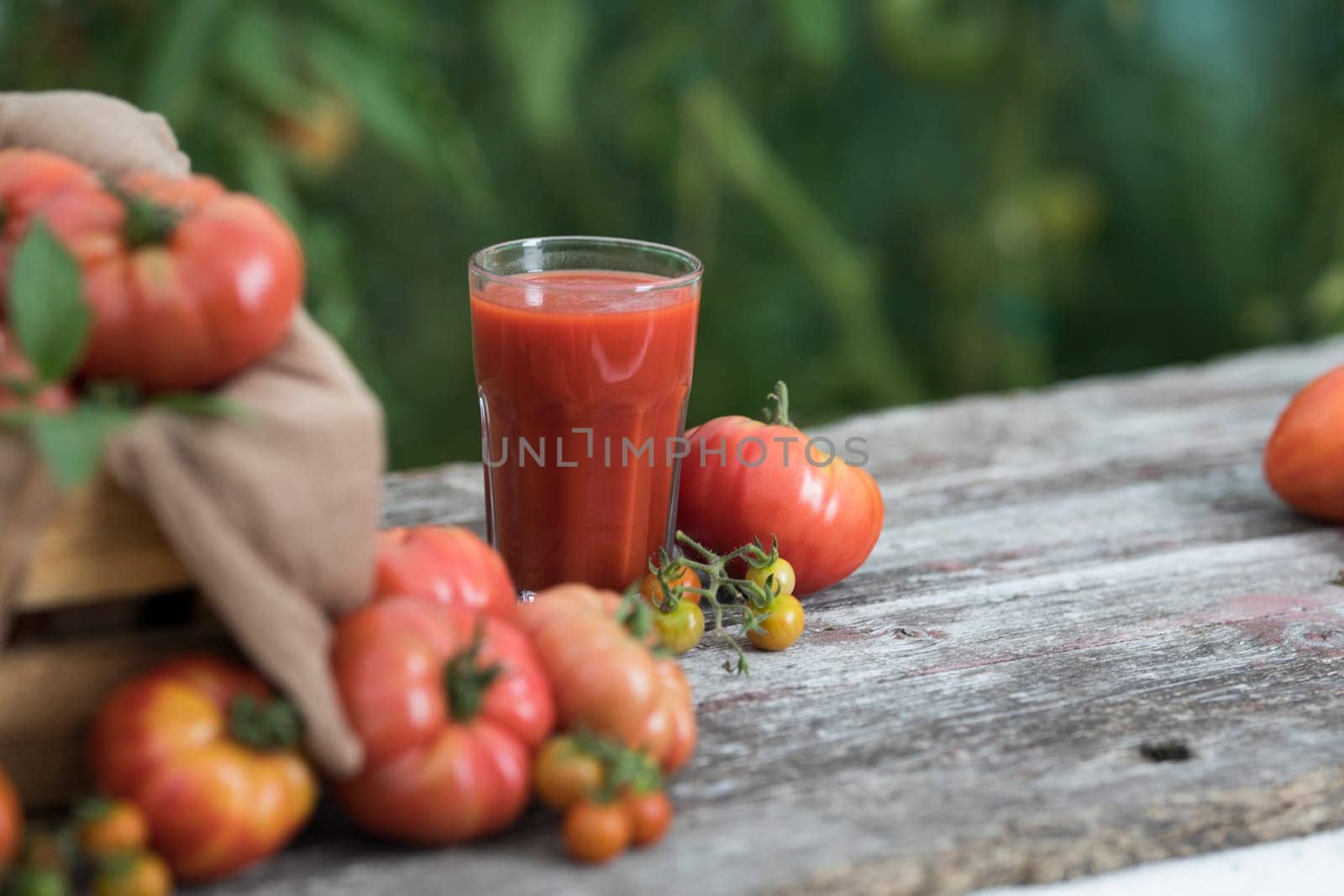 Fresh red tomato juice, on a wooden background