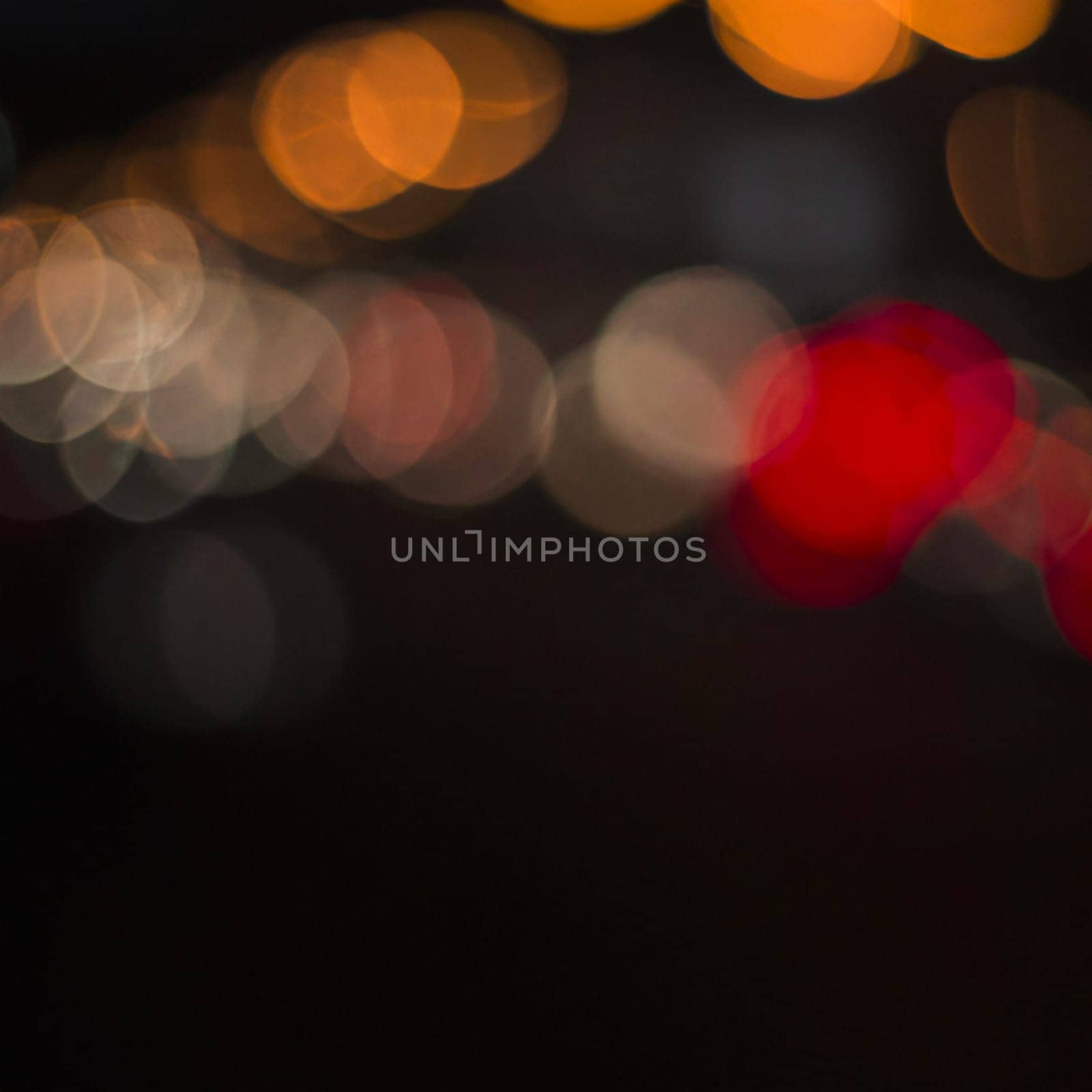 Multicolored abstract round bokeh - beige, orange, gray, red. Bokeh is the blurring of an out-of-focus lens in a photograph. Festive blurred background
