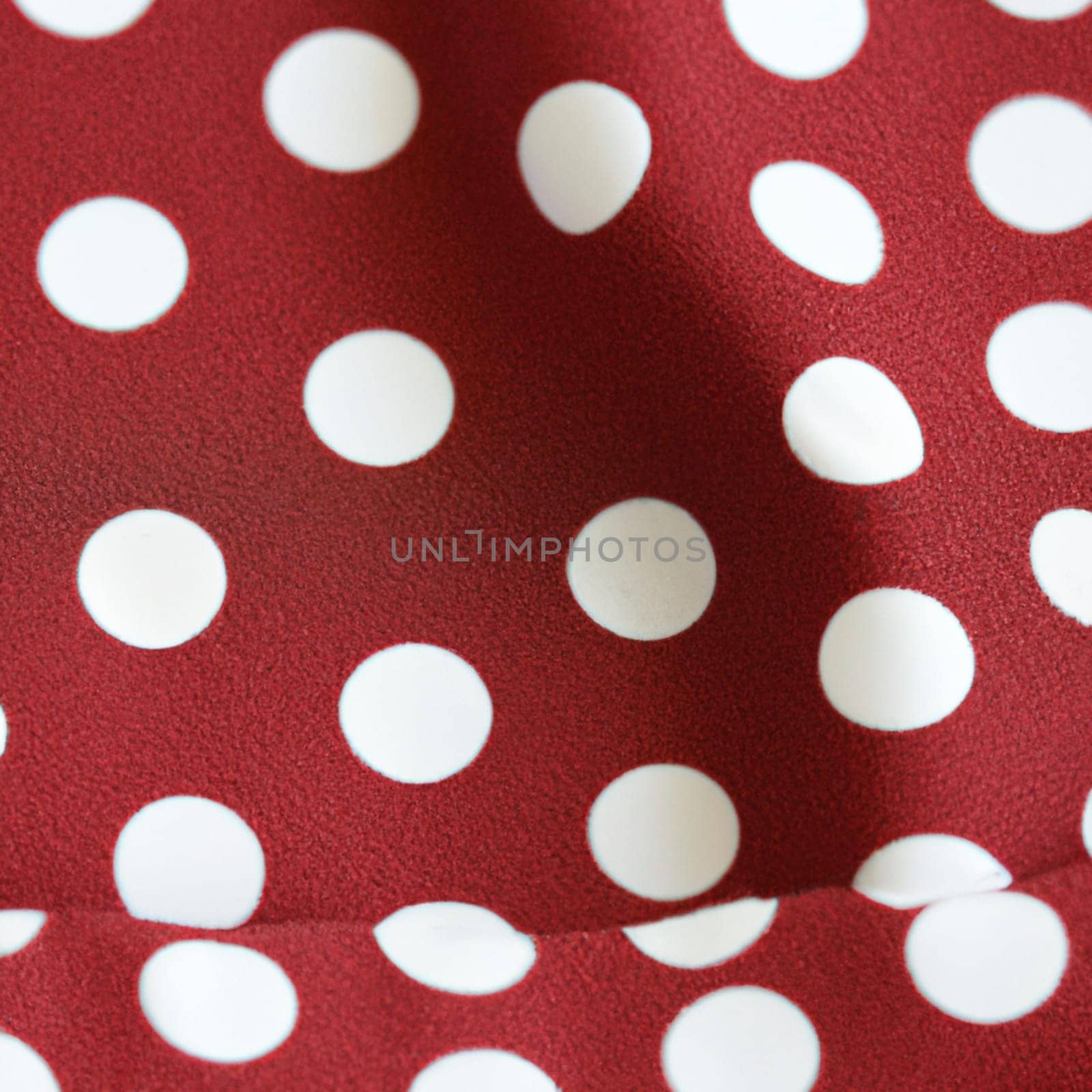 White polka dots on red background, textile fabric surface background