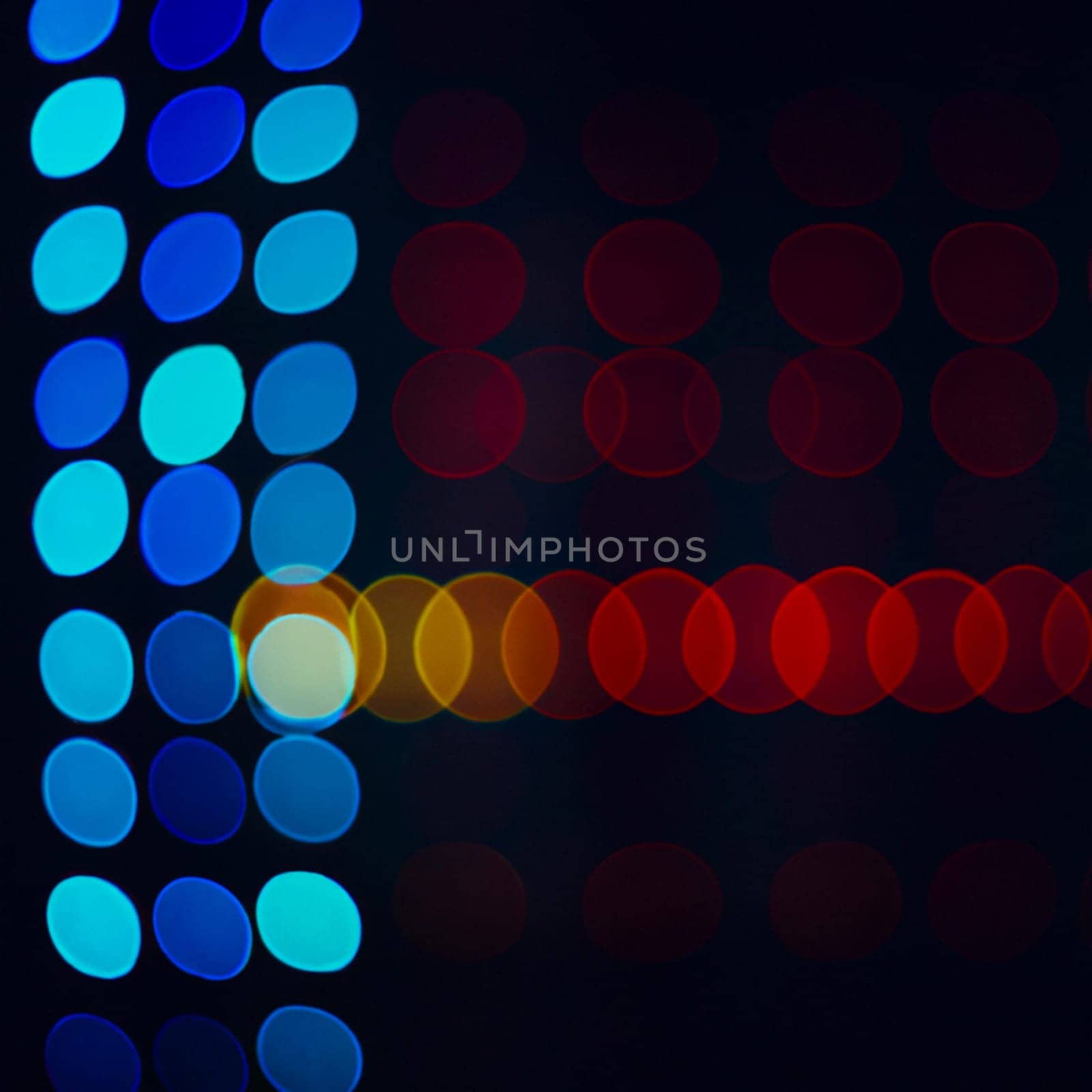 Multicolored abstract round bokeh - blue, white, yellow, orange, red. Bokeh is the blurring of an out-of-focus lens in a photograph. Festive blurred background