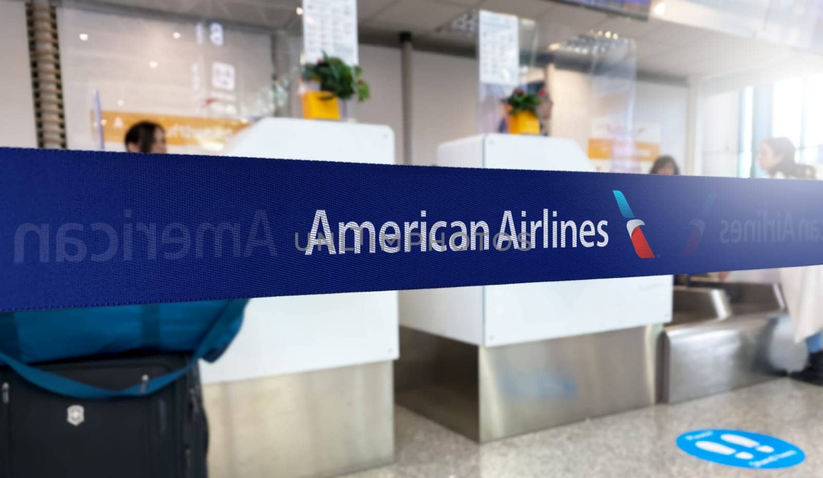 Dallas, US Jan 2023: Blue barrier tape with the American Airlines logo inside an airport. American Airlines is largest airline in the world. Travel and airport security. Illustrative editorial