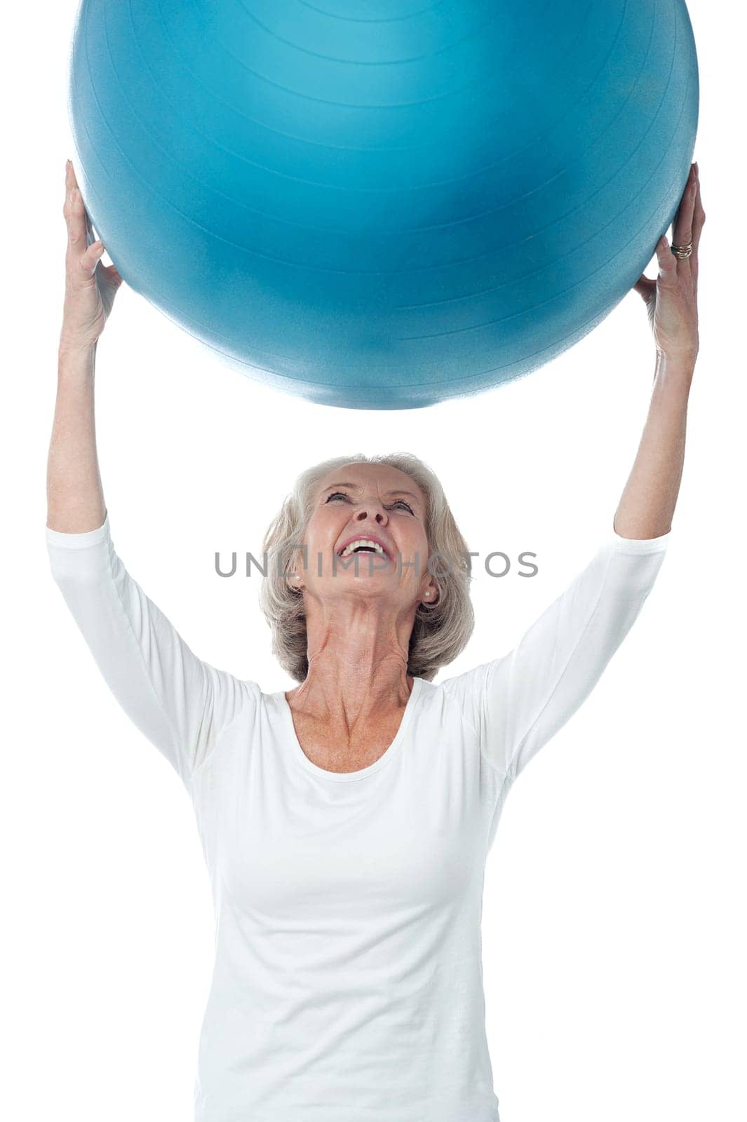 Senior woman holding up the exercise ball