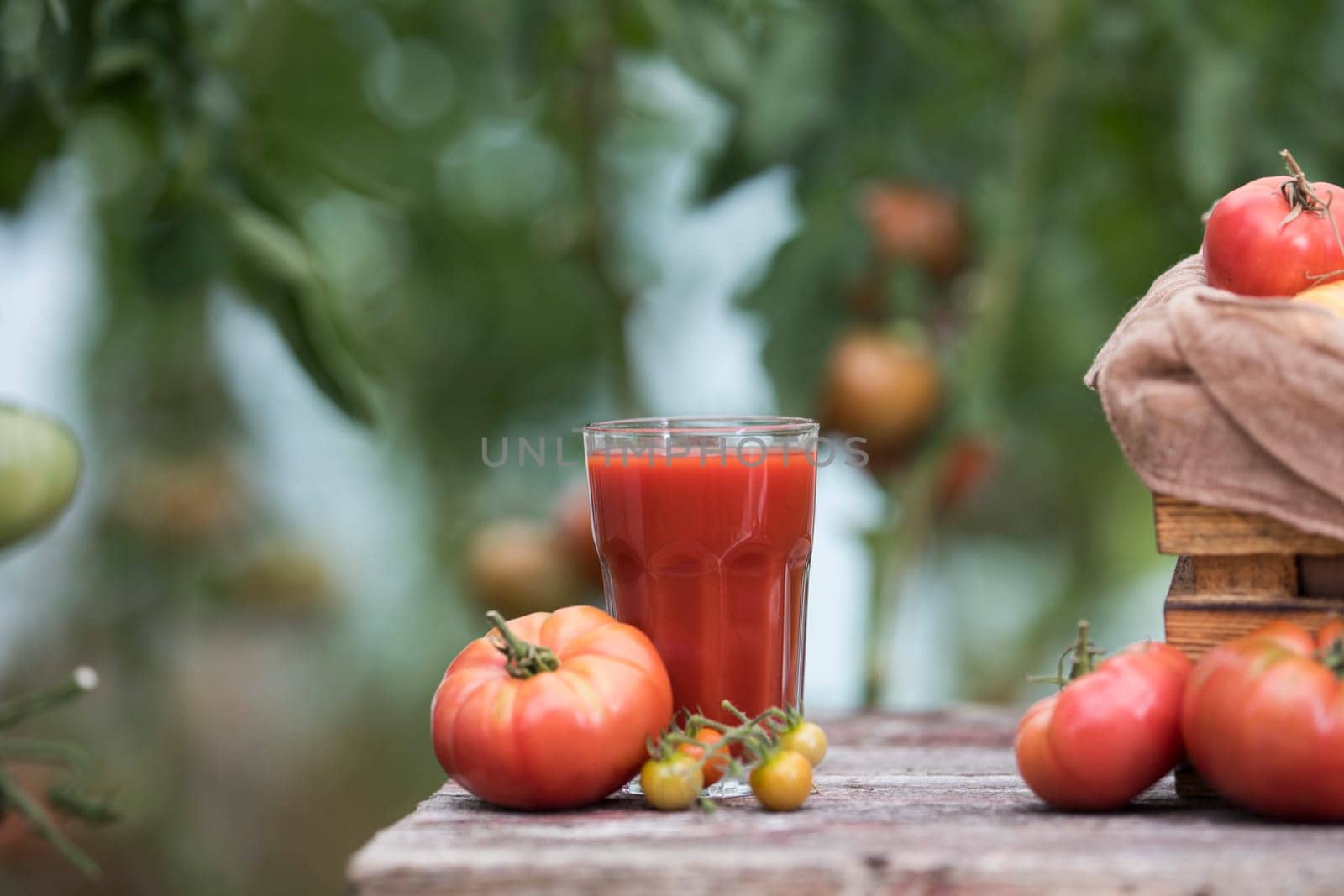 Fresh red tomato juice, on a wooden background
