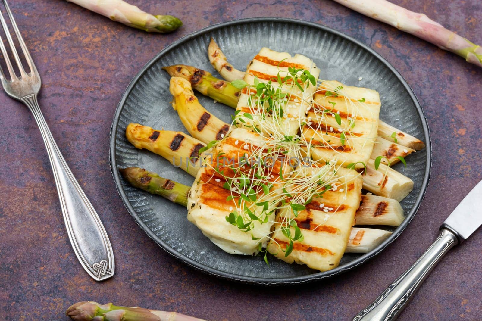 Vegetarian food of white asparagus and fried halloumi cheese. Top view.