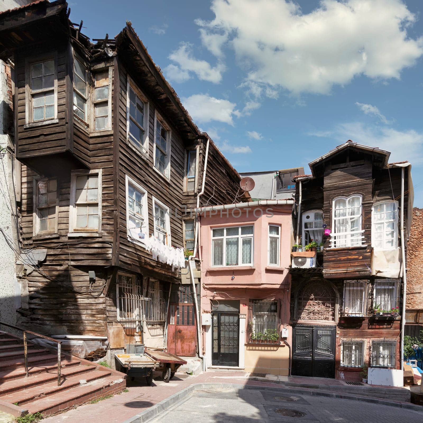 Beautiful old traditional wooden and stone houses, and stone staircase, in old Balat district, on a summer day, Istanbul, Turkey