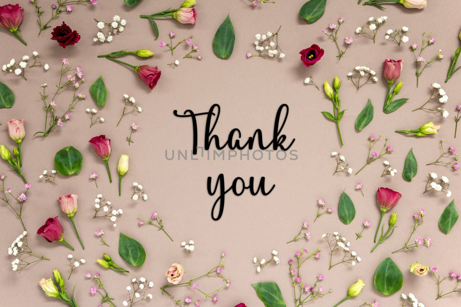 Flower Arrangement With English Text Thank You. Colorful Spring Blossoms And Flowers Like Roses Building A Frame. Flat Lay With Brown Paper Background