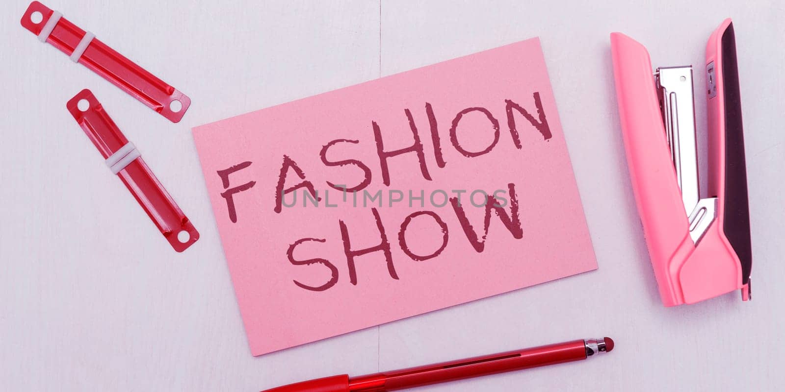 Sign displaying Fashion Show, Word Written on exibition that involves styles of clothing and appearance