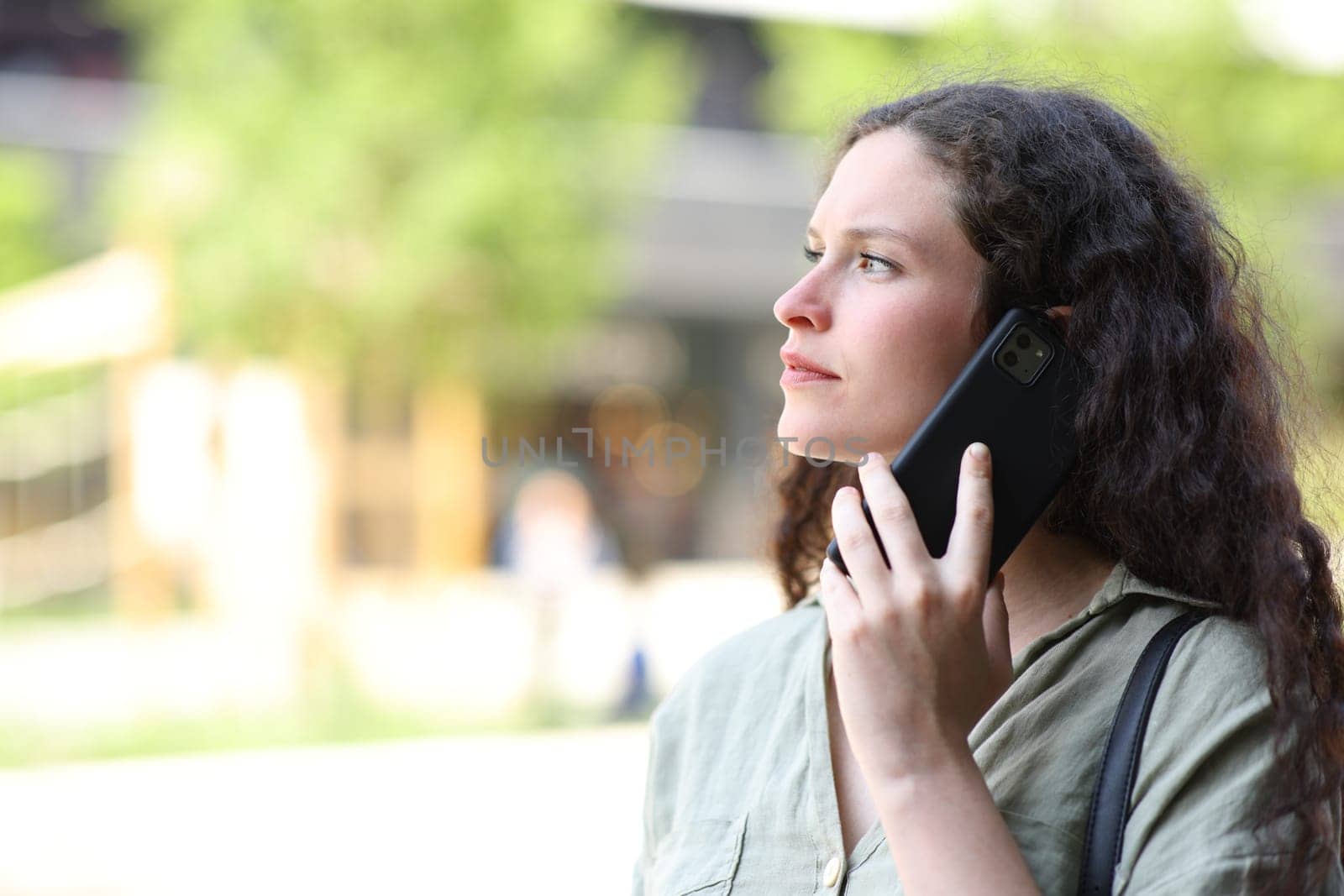 Woman talking on phone walking in the street