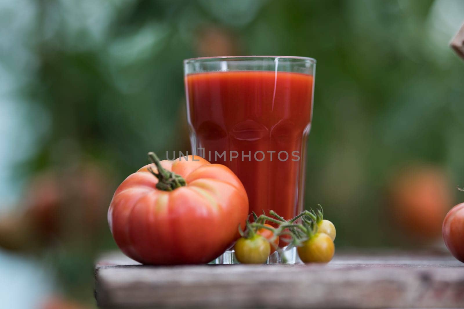 Fresh red tomato juice, on a wooden background