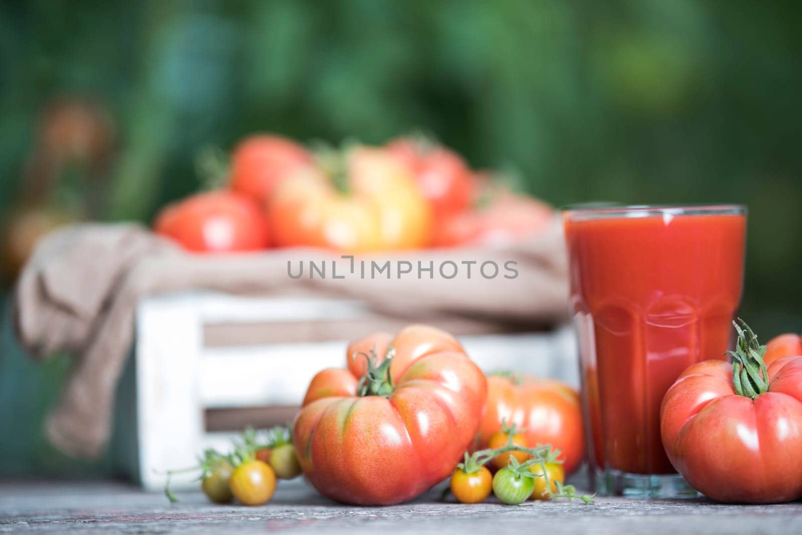 Fresh tomato juice, on a wooden background