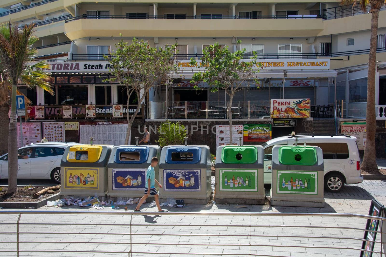 Costa Adeja, Tenerife, Spain August 08, 2022 - Waste bins for waste separation into different containers, in different colors on a street in the city of Costa Adeje on the island of Tenerife, Spain