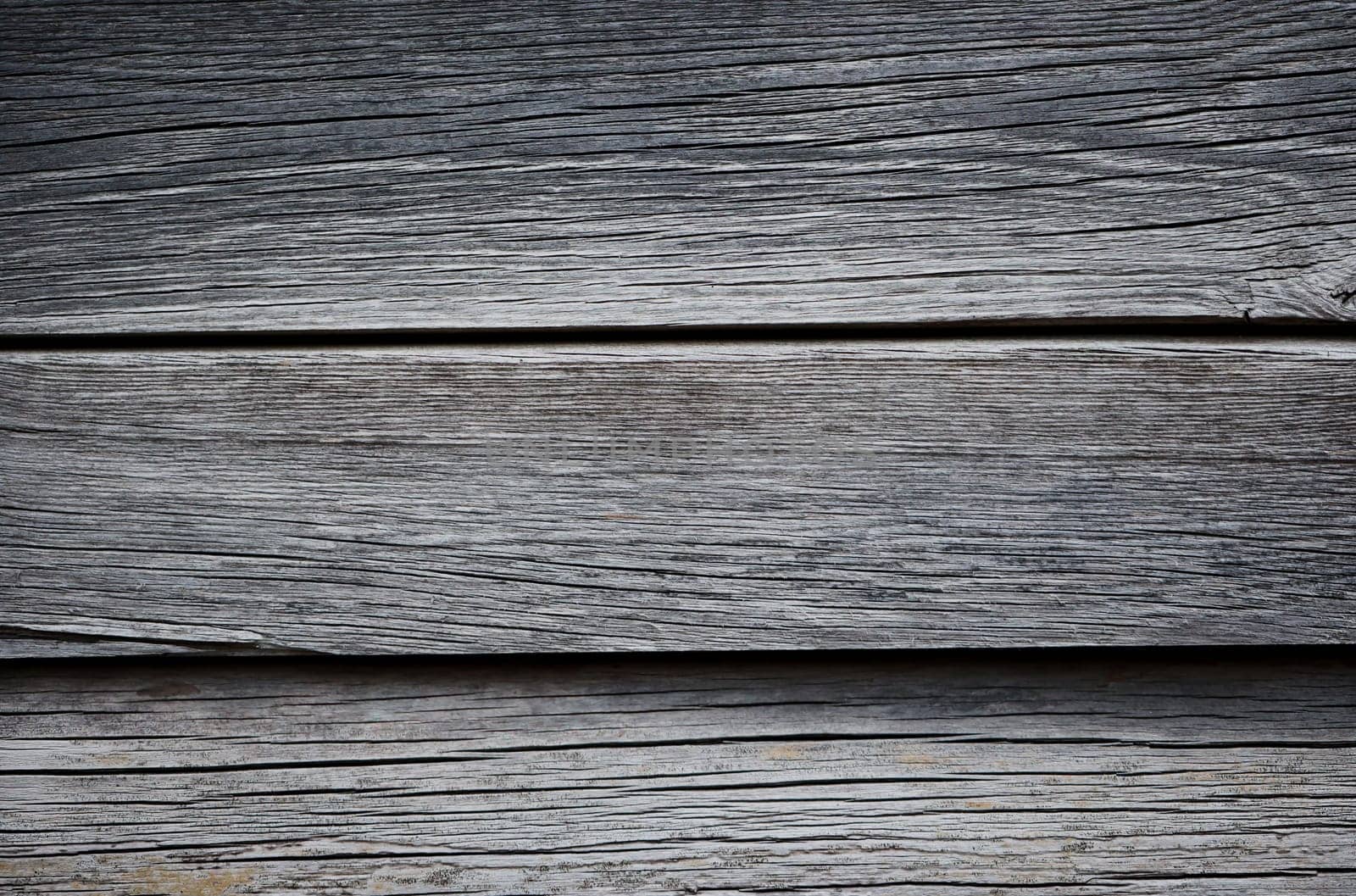 Wooden boards lying next to each other. A wood texture made of several wooden boards.
