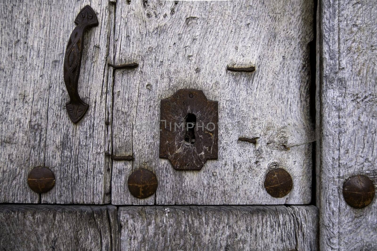 Detail of old wooden door abandoned and damaged by time