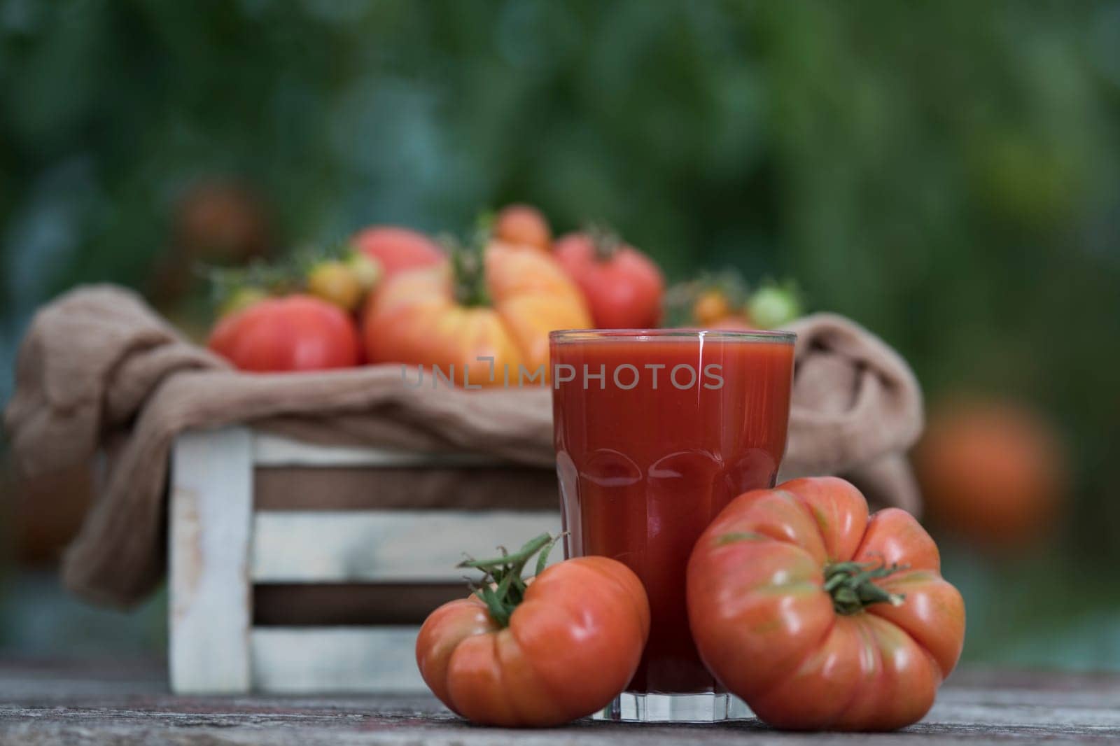 Fresh tomato juice, on a wooden background