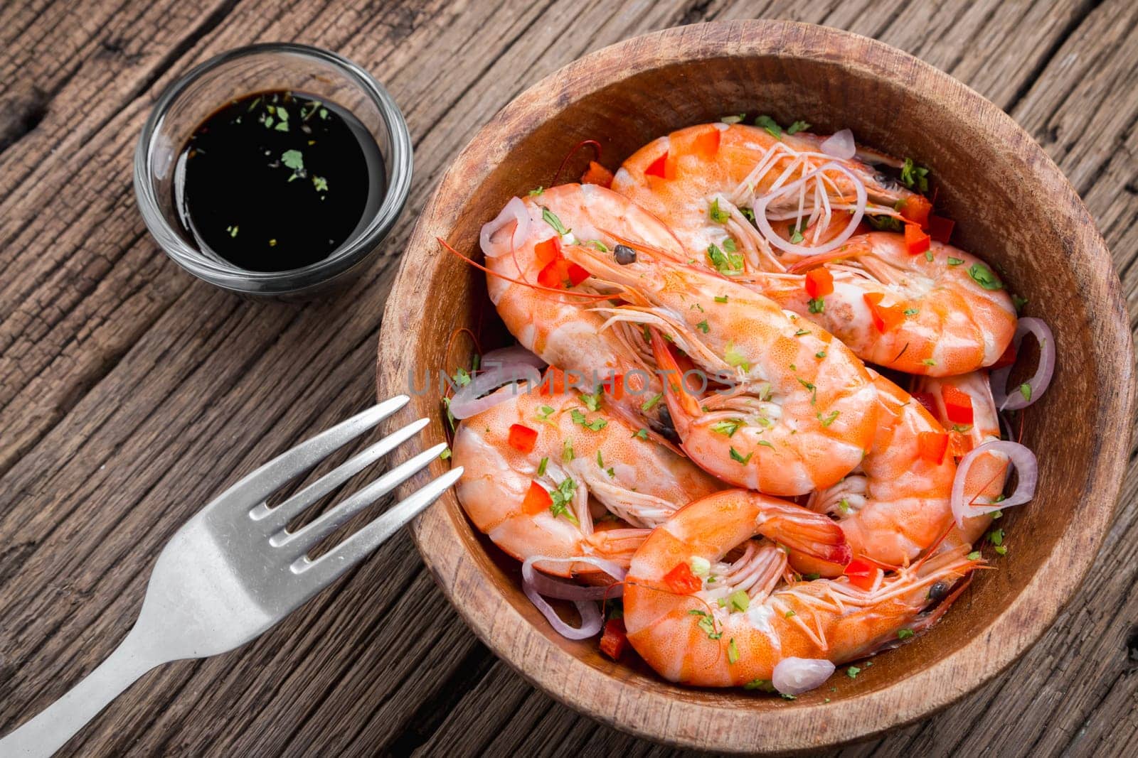 steamed shrimps in a wooden bowl on wood background