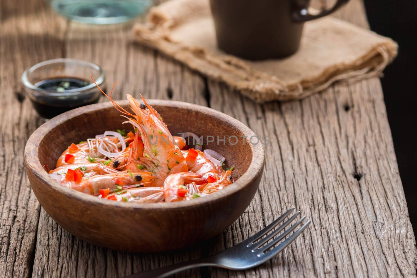 steamed shrimps in a wooden bowl on wood background