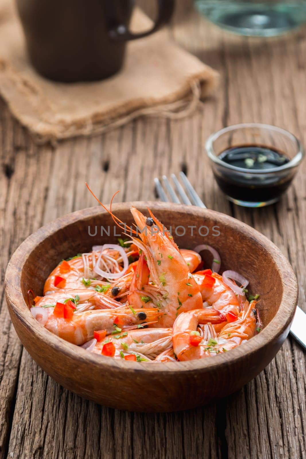 steamed shrimps in a wooden bowl on wood background