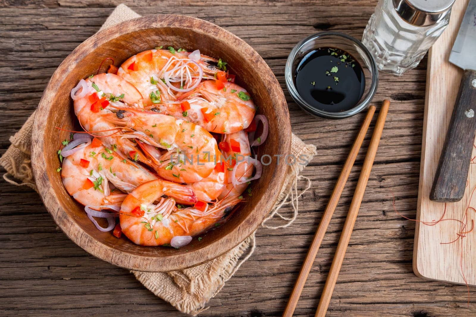 steamed shrimps in a wooden bowl on wood background