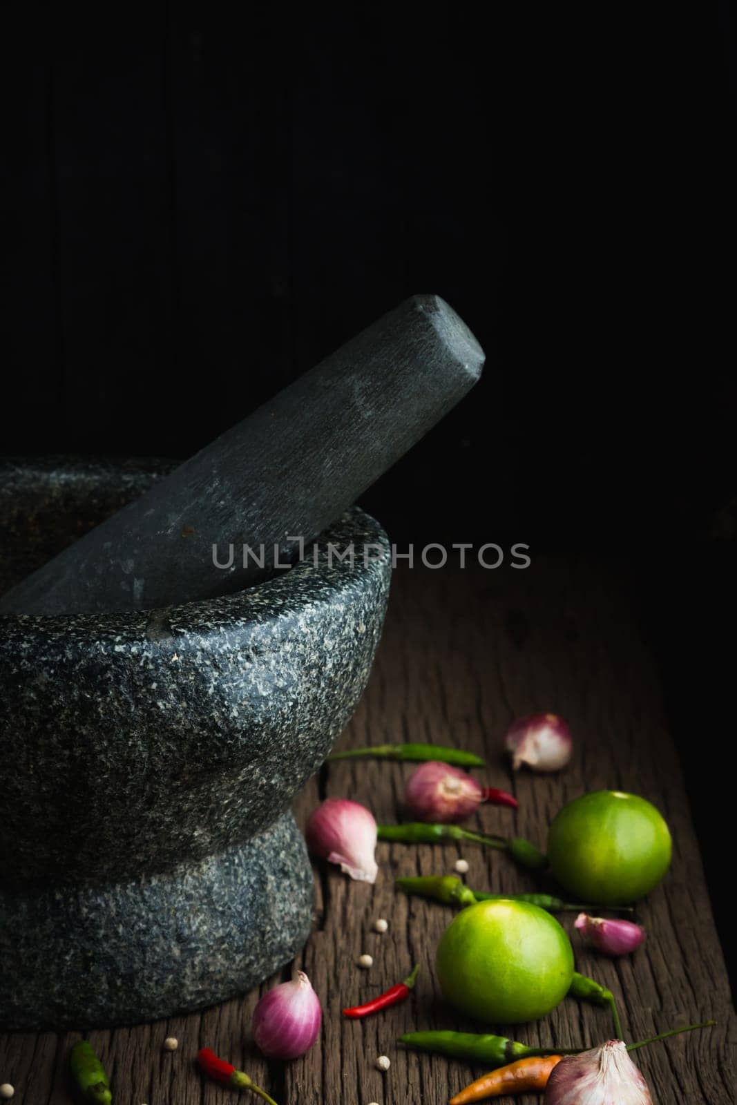 shrimp paste chilli sauce in a mortar stone with Ingredients to cook