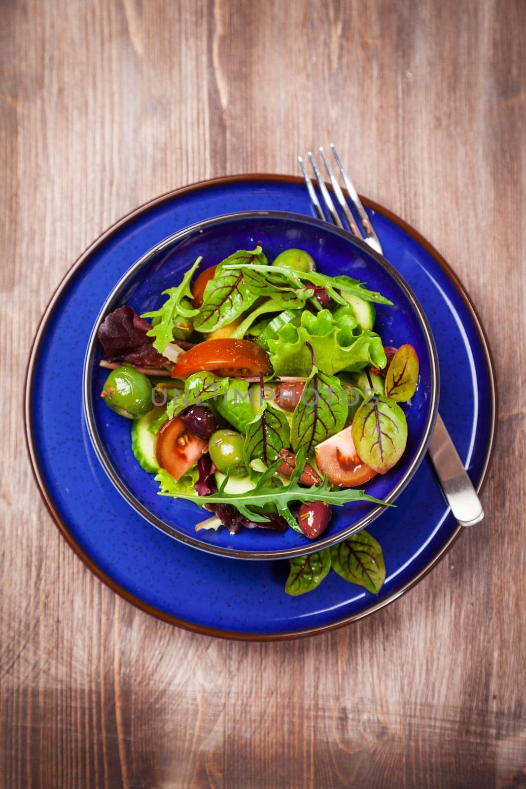 Mixed low calorie salad with olives and fresh avocado