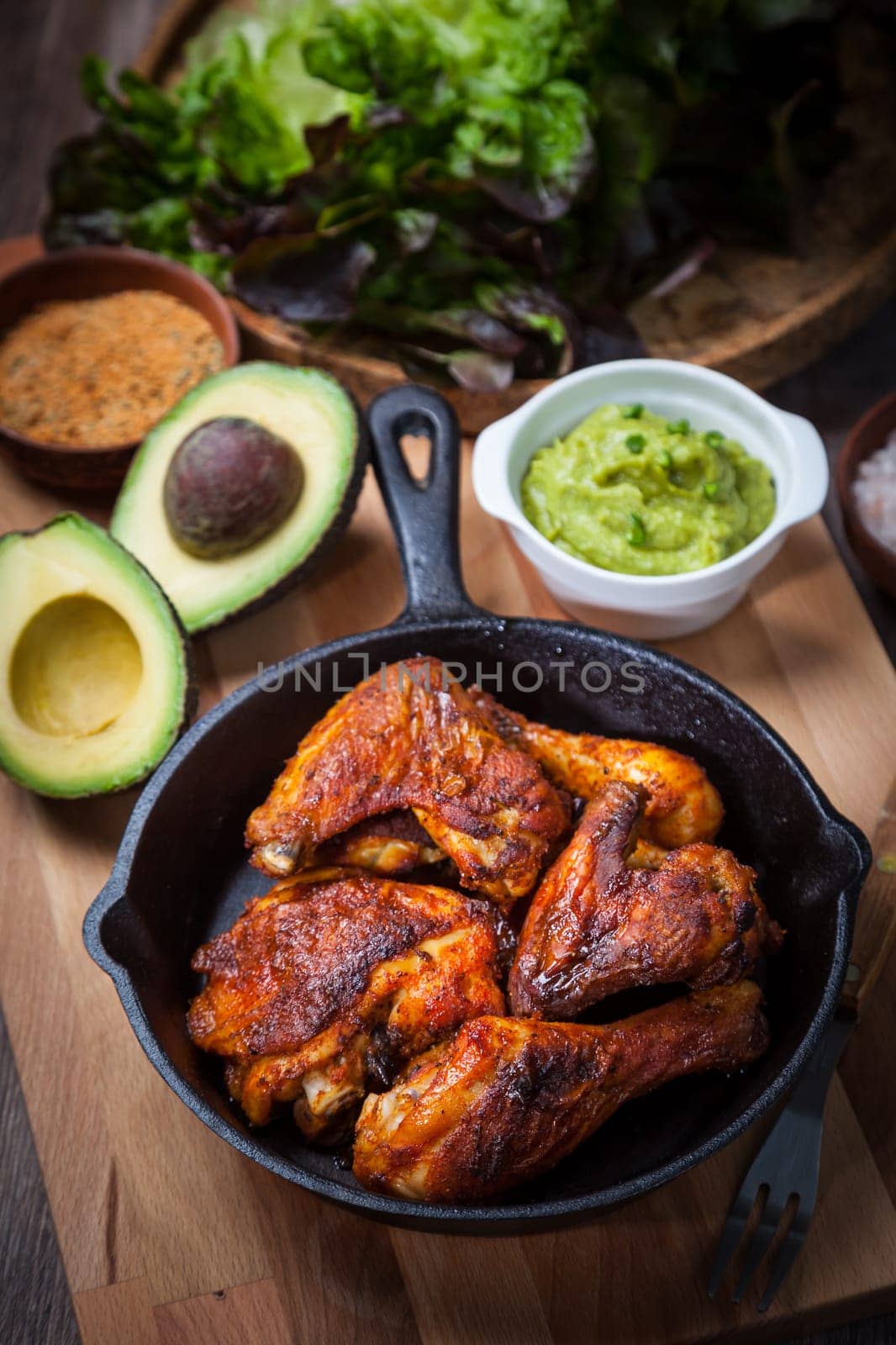 Grilled chicken legs and wings with guacamole, frish salad and spicies