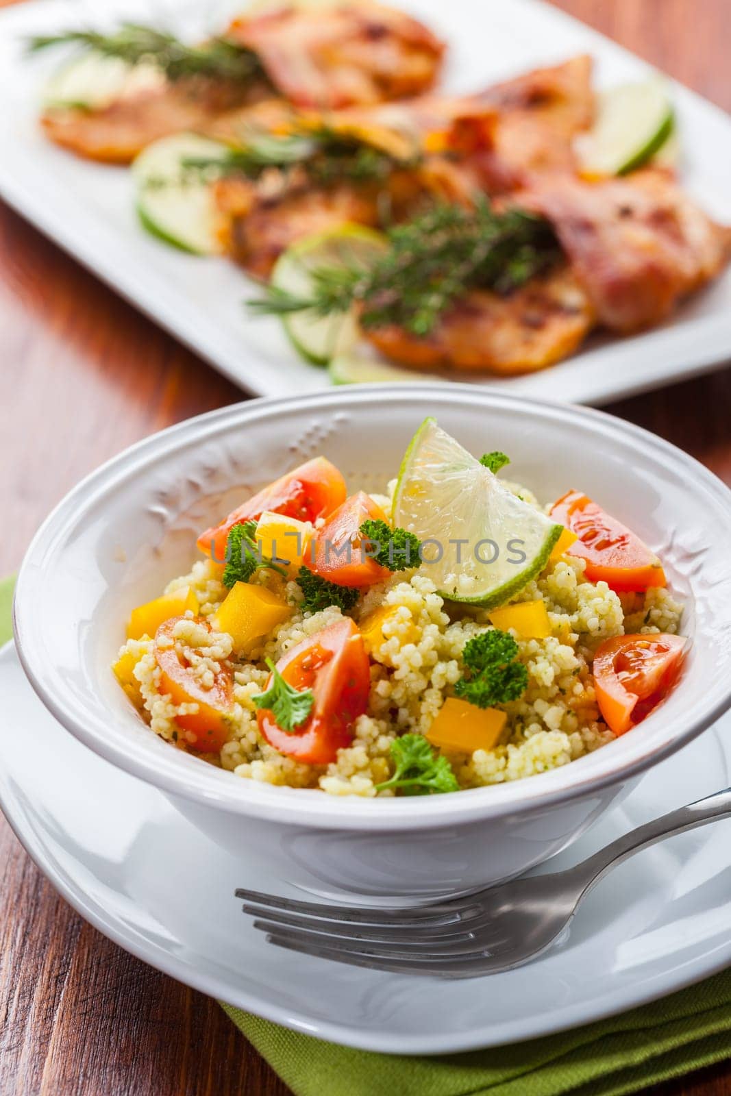 Fresh couscous salad for summer with tomato, pepper with olives