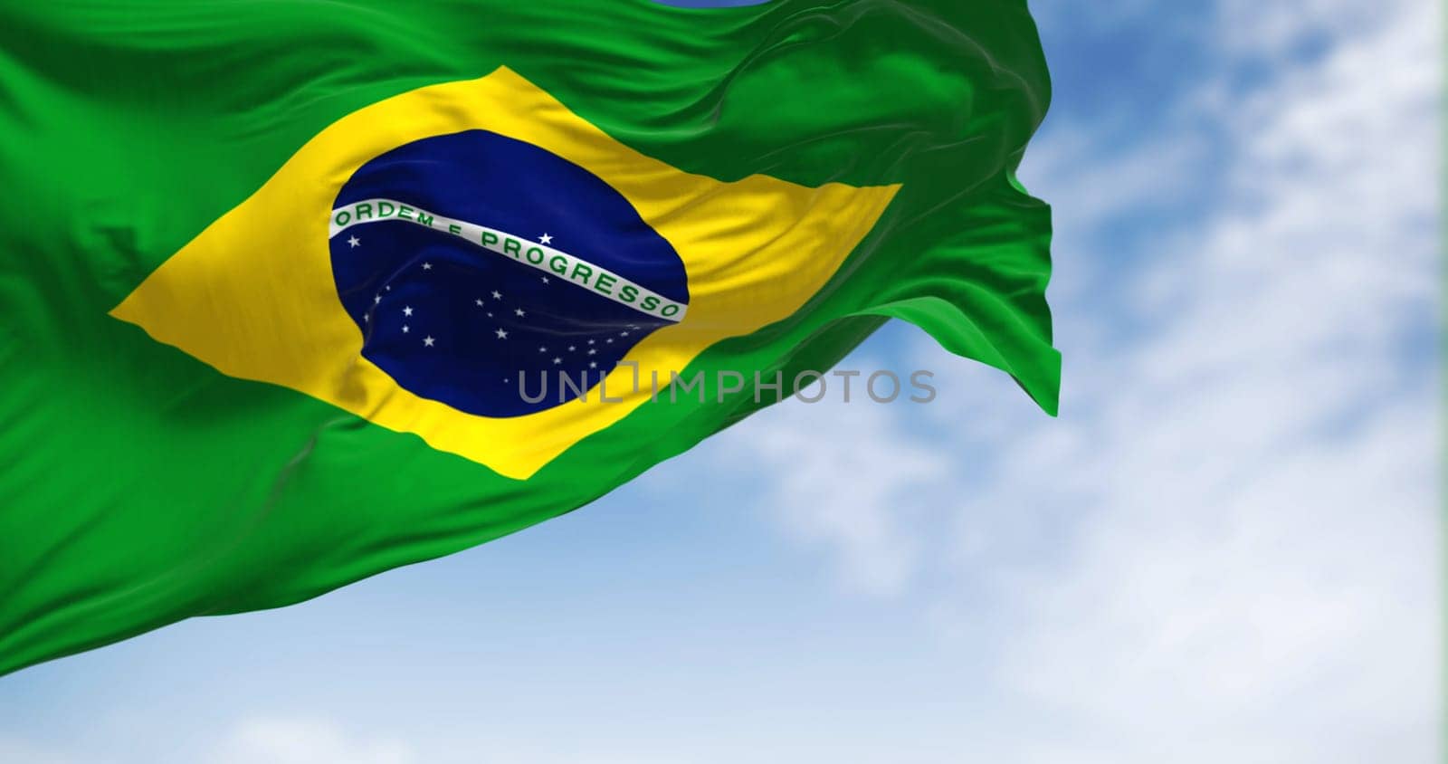Brazil national flag waving on a clear day. Yellow diamond on green field with blue circle of 27 white, five-pointed stars. Fluttering fabric. Realistic 3d illustration.