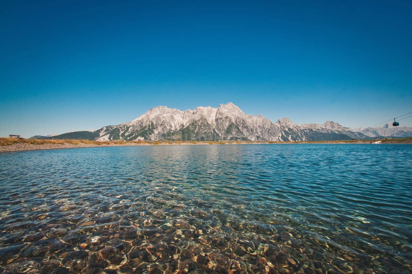 Asitz mountain in the background of the pure and calm lake, Austria