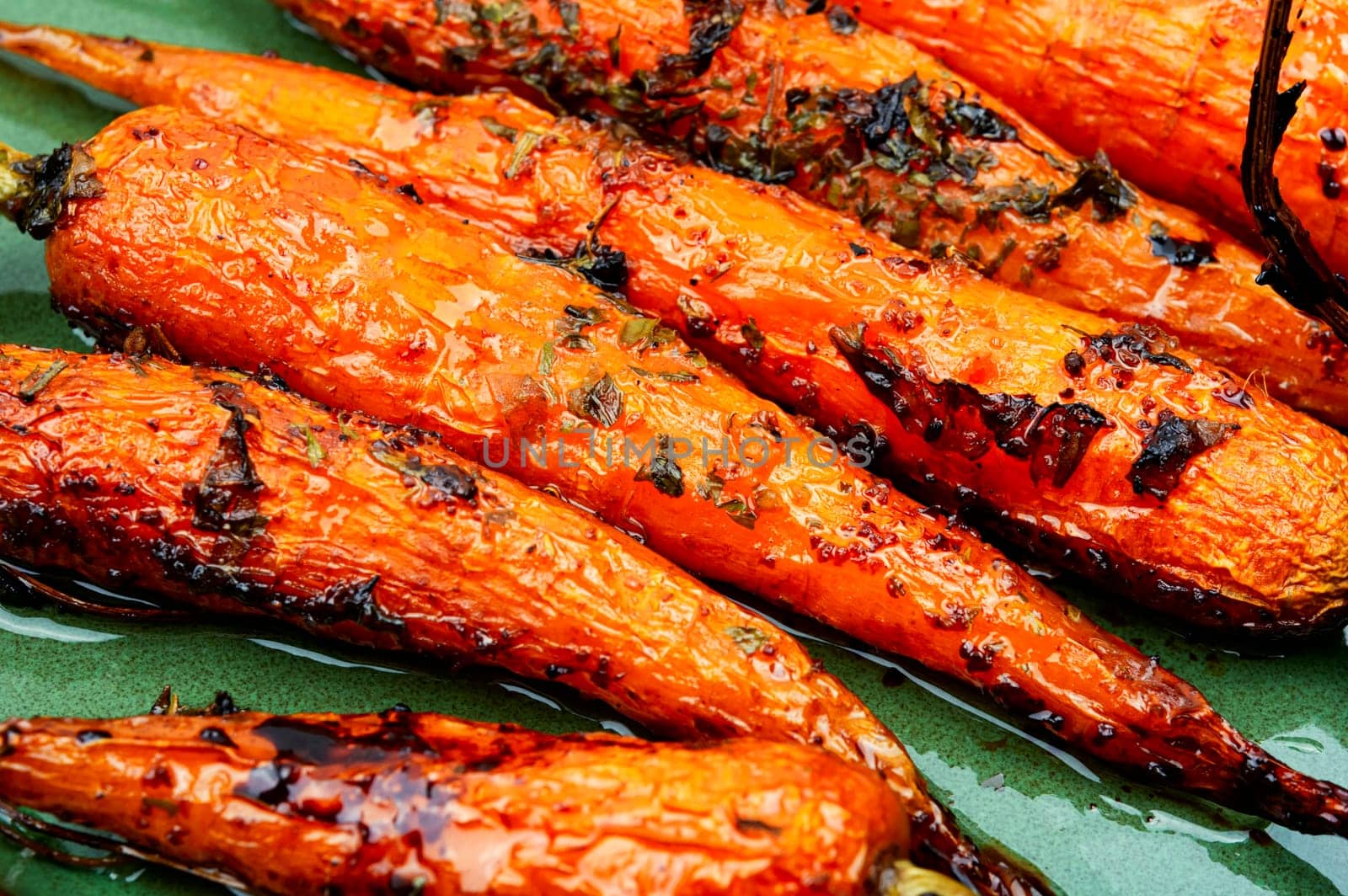 Baked with herbs and spices carrots. Tasty vegetable dish.