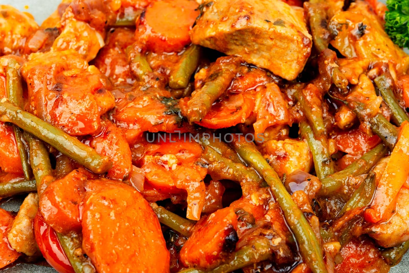 Stewed meat with carrots and green beans. Hot ragout with meat and vegetables.