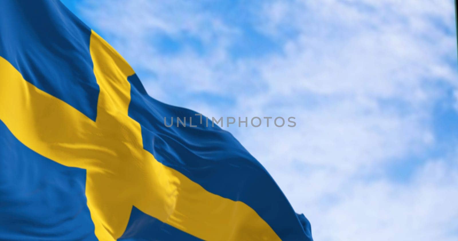 The national flag of Sweden waving on a clear day. Yellow Nordic cross on a blue background. Scandinavian country. 3d illustration render. Rippled fabric. Textured background