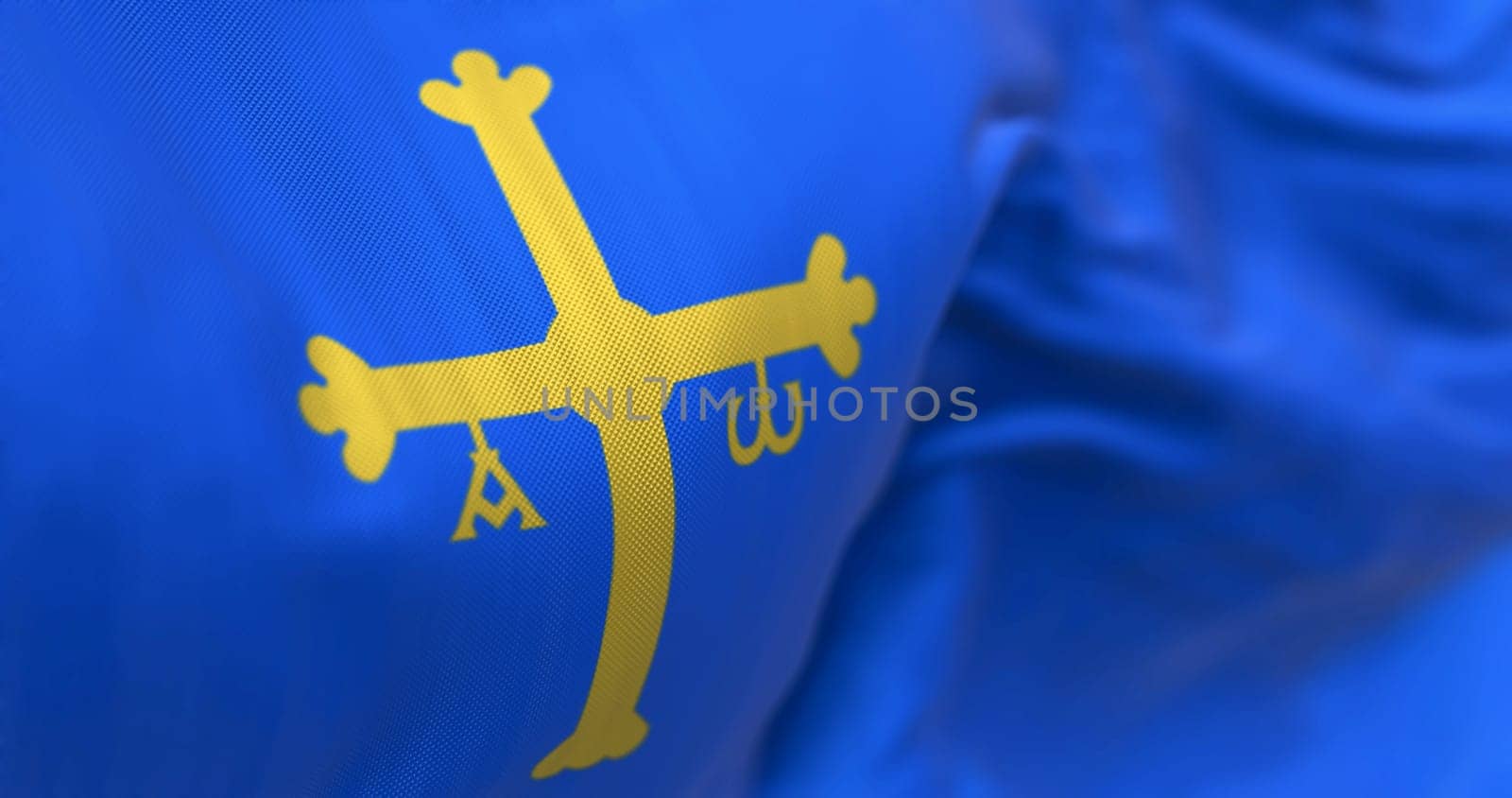 The Asturias flag waving. Autonomous community in northern Spain. Blue with golden victory cross shifted towards the hoist side. Selective focus. 3d illustration render. Close-up. Textured background