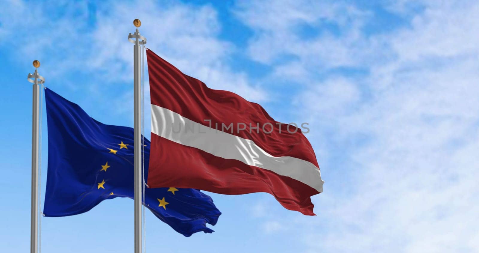 The flags of Latvia and the European Union fluttering together on a clear day. Latvia became a member of the European Union on 2004. 3d illustration render. International treaty and diplomacy