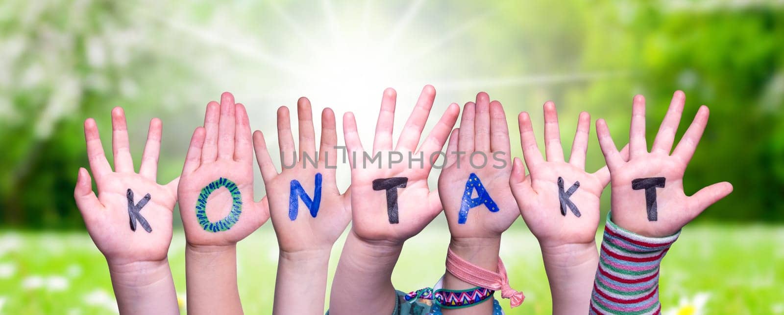 Children Hands Building Colorful German Word Kontakt Means Contact. Sunny Green Grass Meadow As Background.