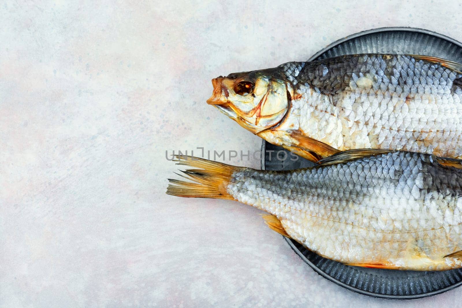 Dried salted fish on the table. Salted fish for beer.