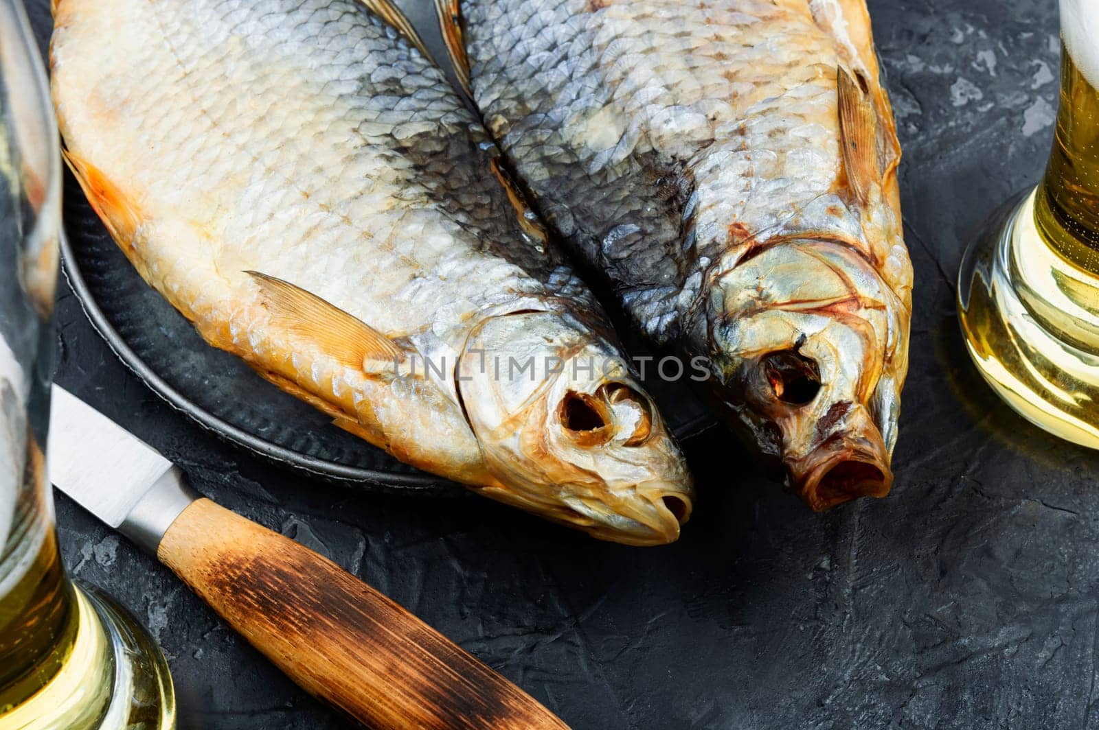 Dried salted fish on the table. Salted fish for beer.