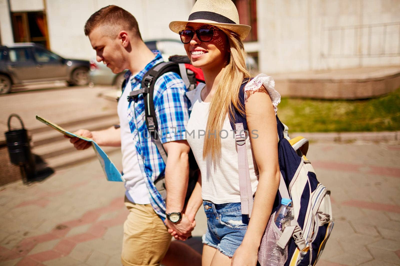 Affectionate couple of tourists enjoying weekend in foreign city