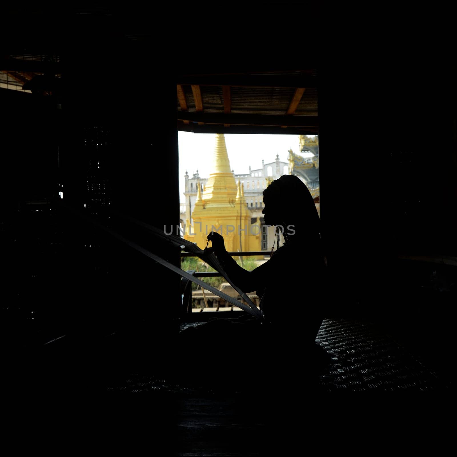 a padaung women in a traditional weaving workshop Factory near the Village of Phaung Daw Oo at the Inle Lake in the Shan State in the east of Myanmar in Southeastasia.