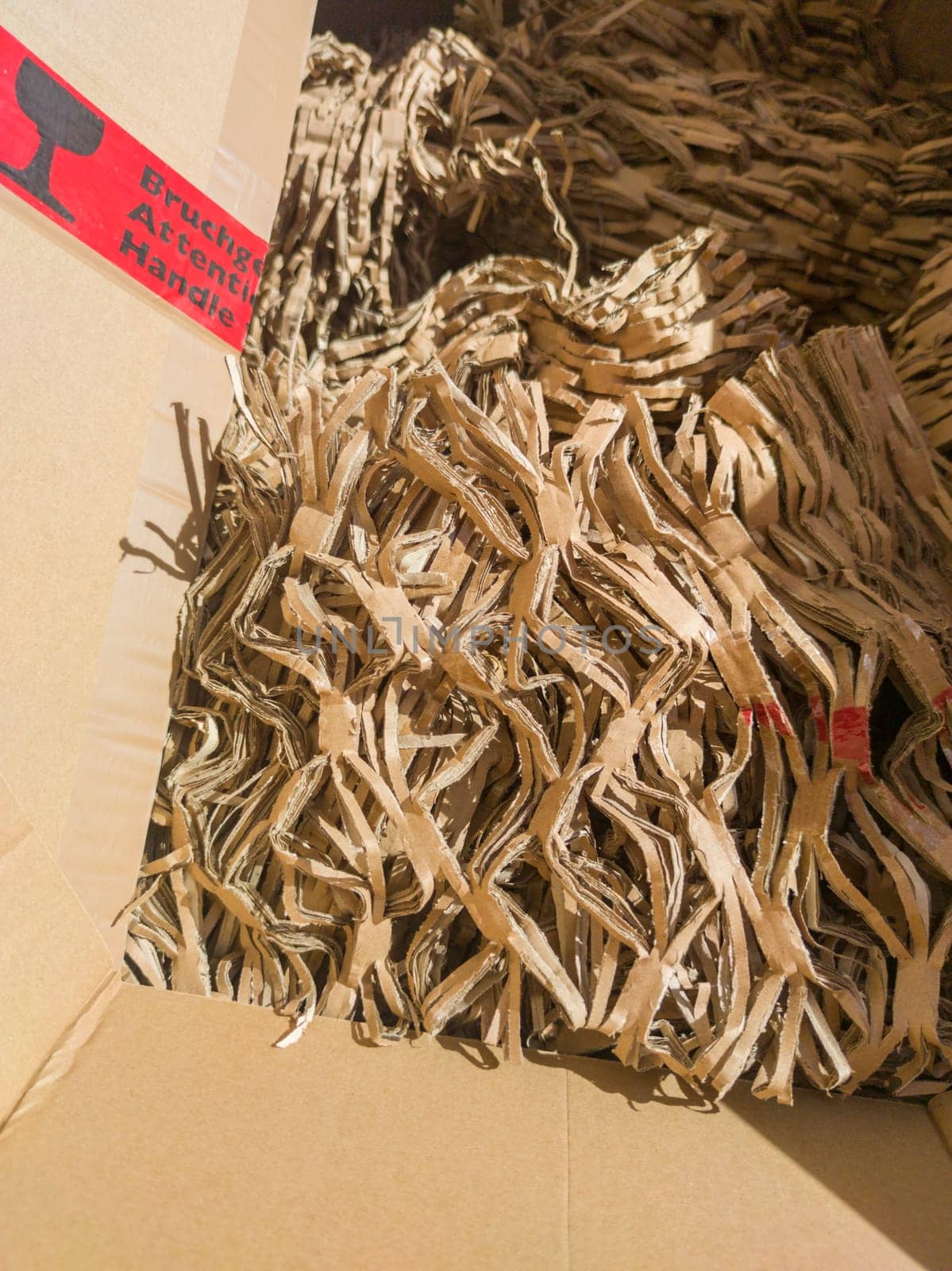 Box with shredded cardboard filler material. Eco-friendly packaging concept