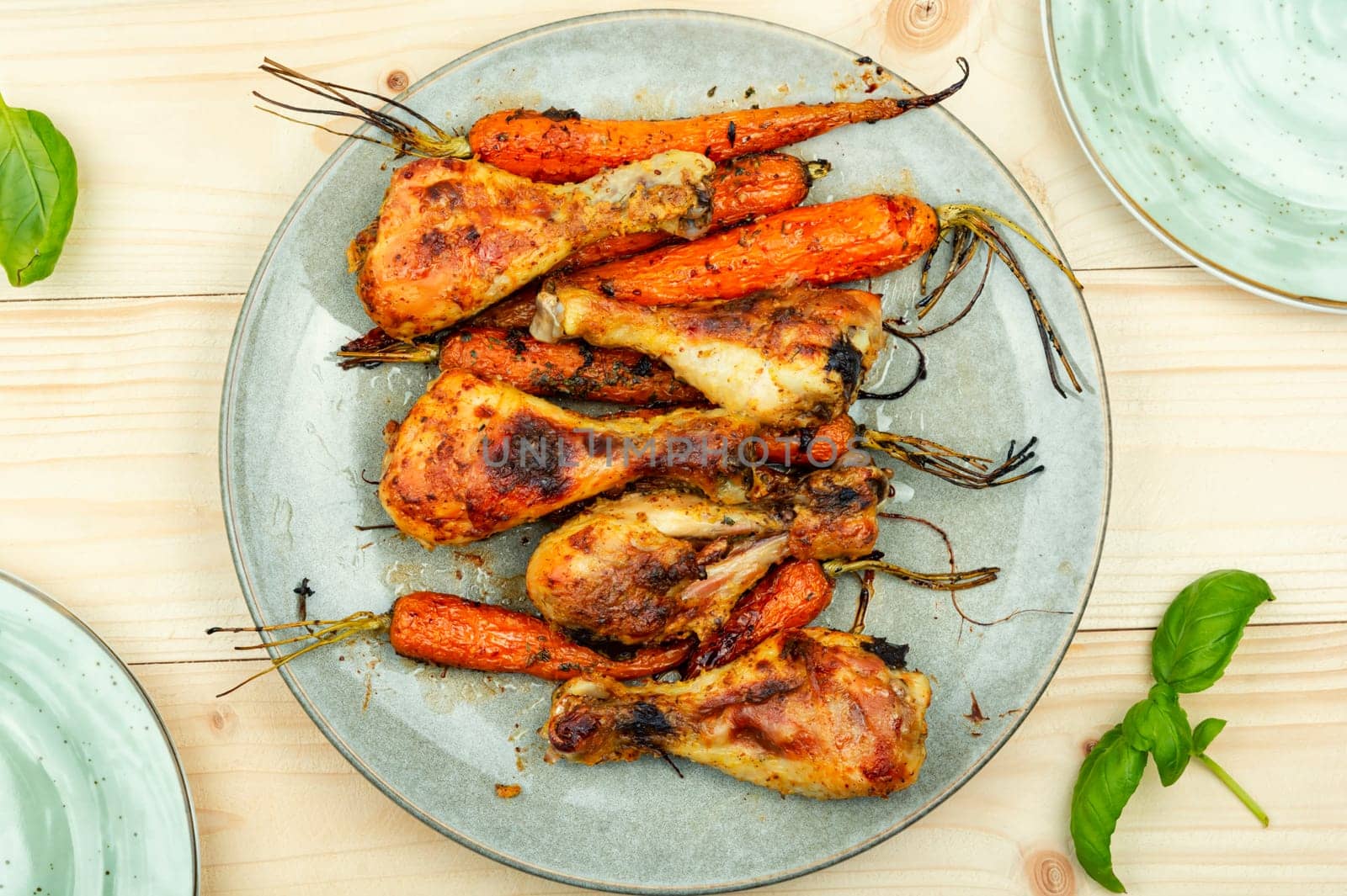 Appetizing chicken legs baked with vegetables. Homemade barbecue
