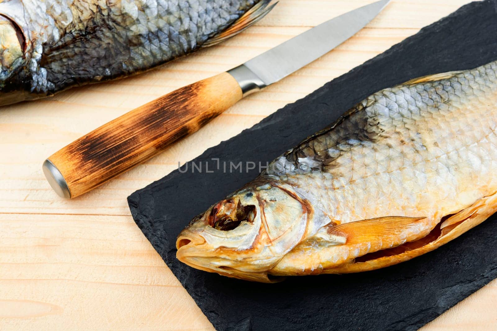 Dried salted fish on the wooden table. Sun dried fish.