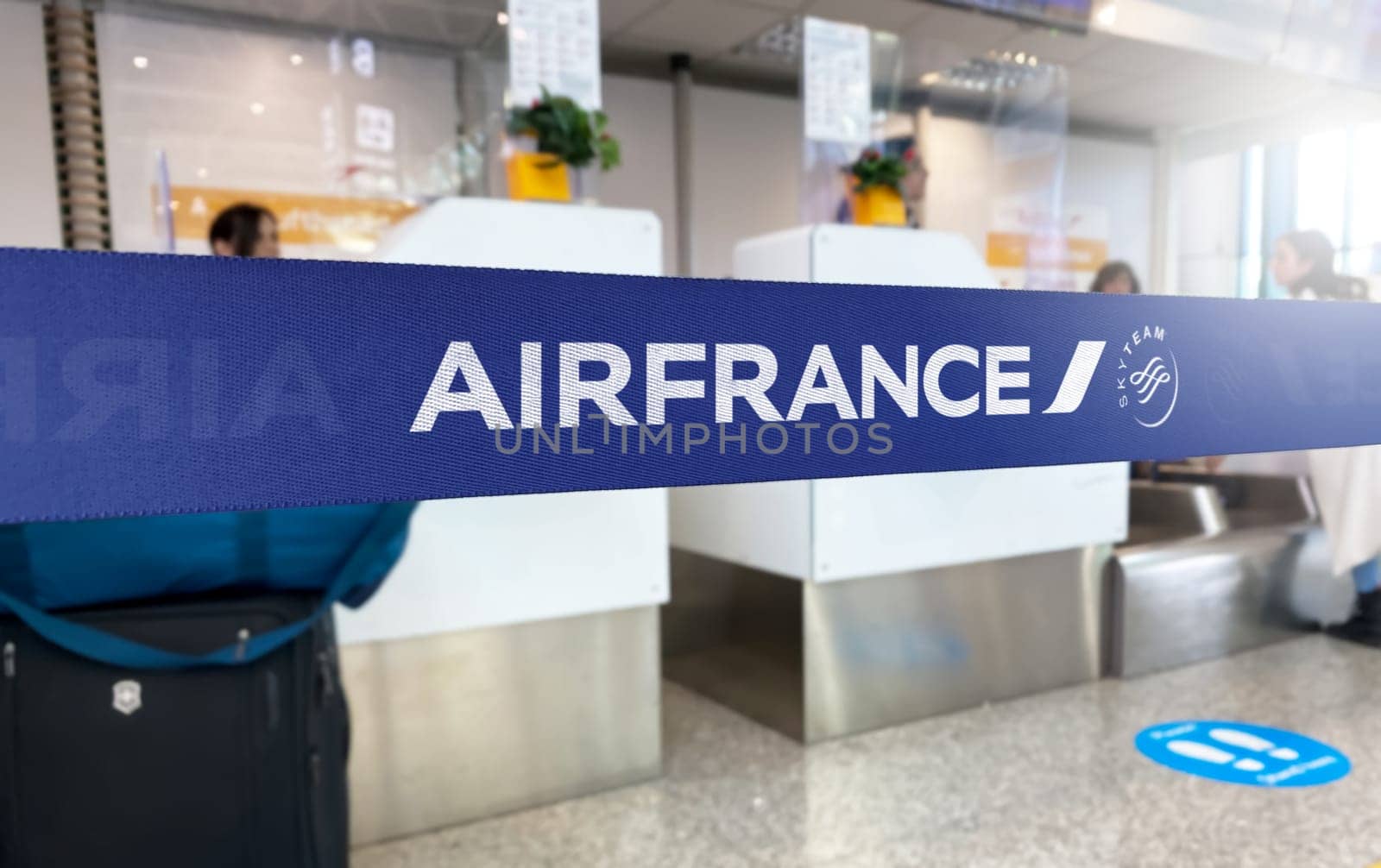 Paris, FR Jan 2023: Blue barrier tape with the Air France and SkyTeam logo inside an airport. Air France is the flag carrier of France. Travel and airport security. Illustrative editorial