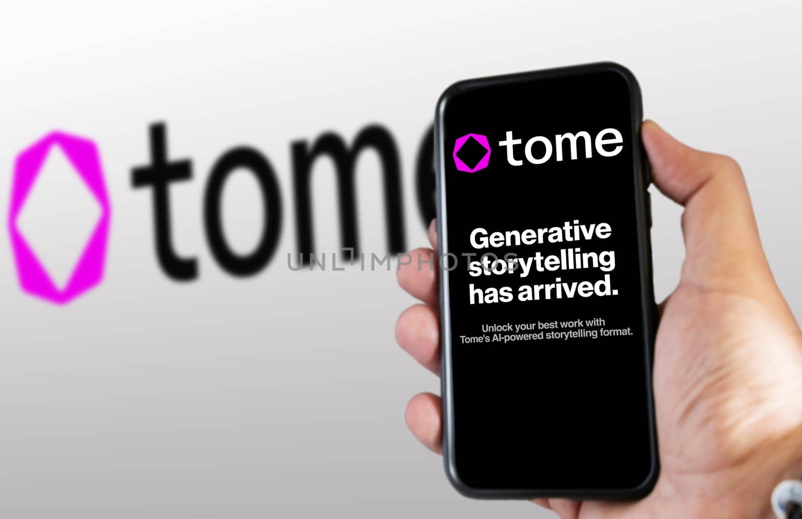 San Francisco US, March 2023: hand holding a phone with Tome website on the screen. Tome is an AI-powered storytelling format. Illustrative editorial