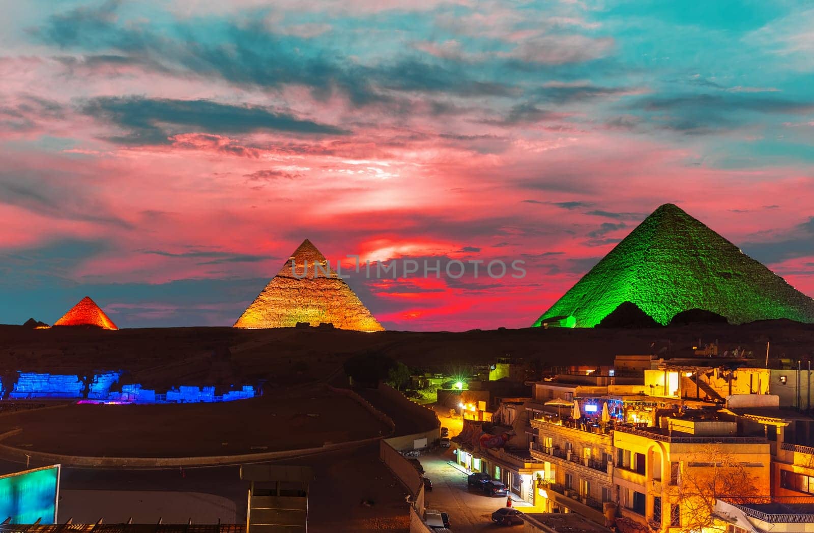 The Great Pyramid complex enlighted at night, Giza, Egypt.