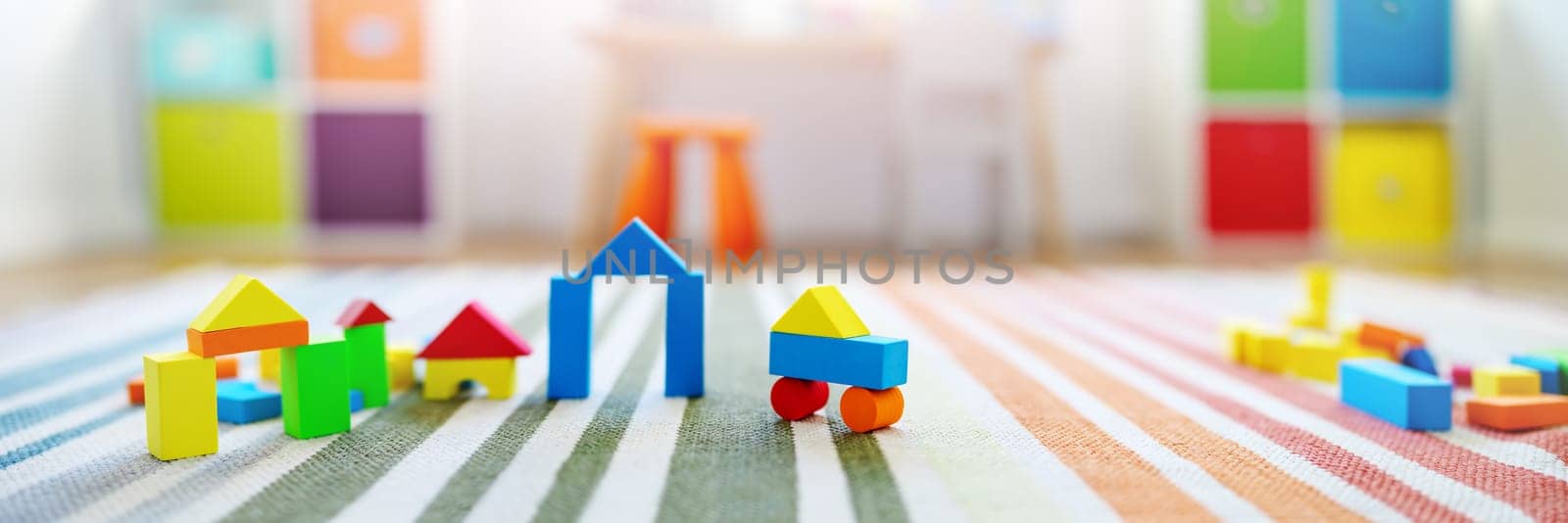 Panoramic background of the colourful blocks in playroom. Concept of the wallpaper and banner.