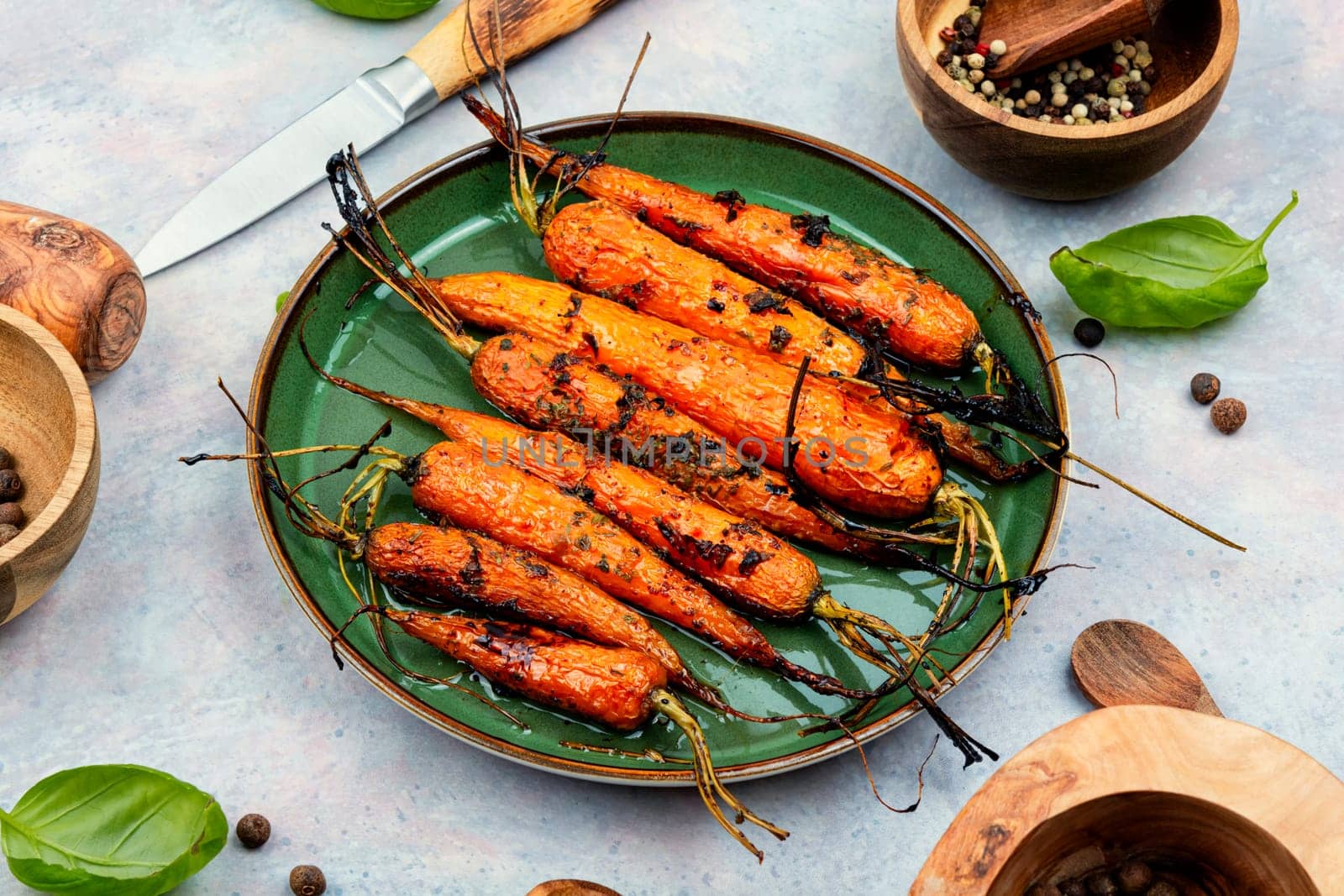 Roasted with herbs and spices whole carrots. Vegetarian healthy appetize.
