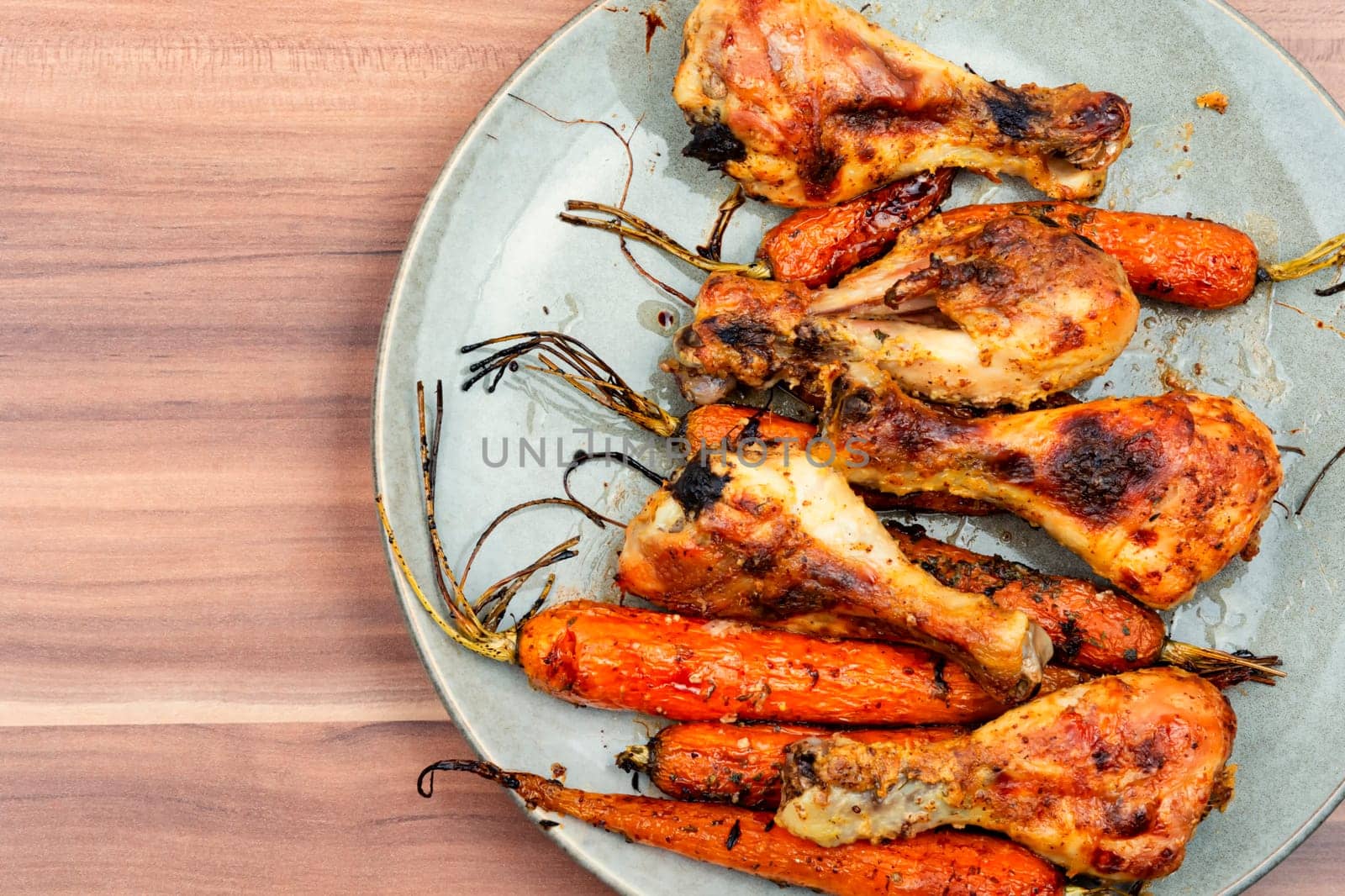 Grilled chicken drumsticks, roast chicken legs with carrots