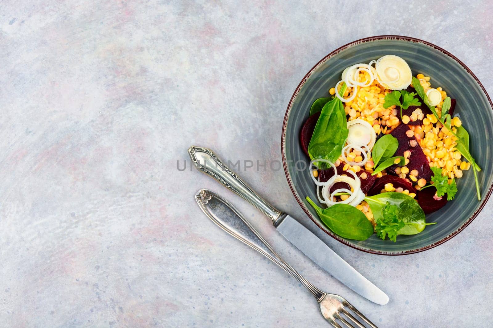 Salad with beets,red lentils, onions and herbs in bowl. Healthy eating. Flat lay